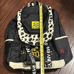 Black and White Backpack with Yellow Logo.